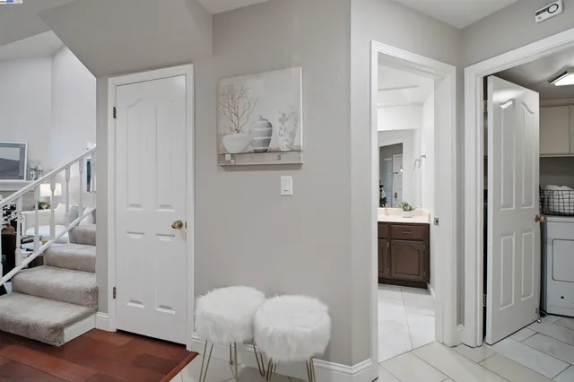 a view of a hallway with wooden floor and staircase