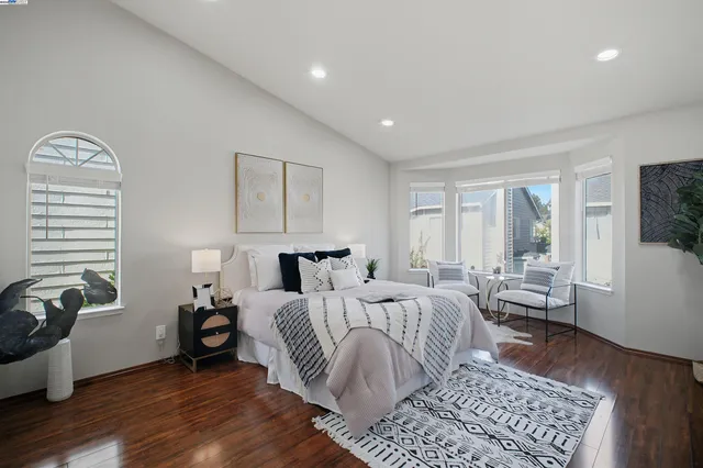 a bedroom with a bed and a mirror