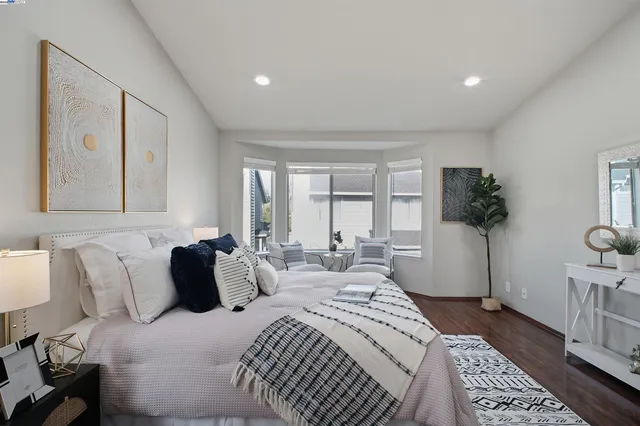 a spacious bathroom with a double vanity sink a toilet and a mirror