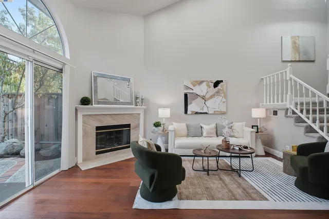 a living room with furniture and a fireplace