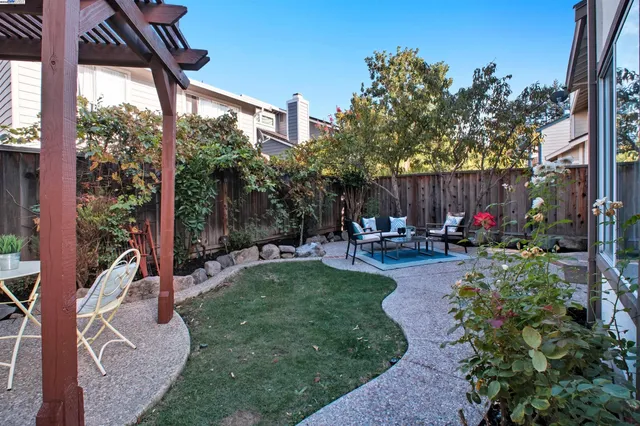 a view of patio with a table and chairs and potted plants
