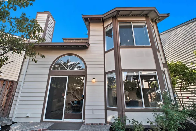 a view of a hallway with furniture and dining room view