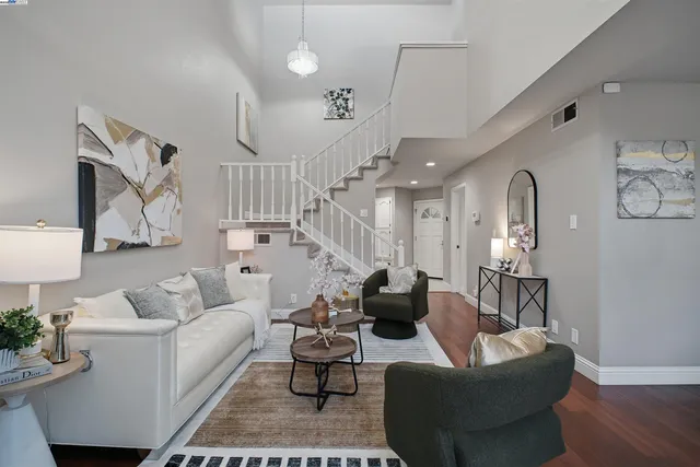 a living room with furniture and a lamp