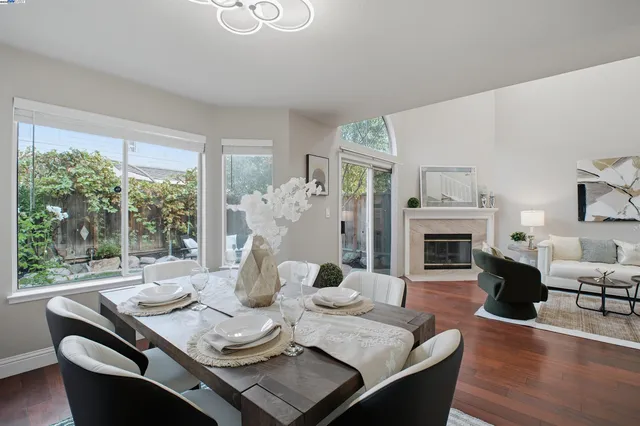 a living room with furniture fireplace and a table