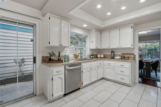 a kitchen with white cabinets and white appliances