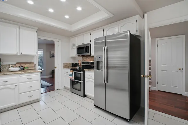 a living room with furniture fireplace and a large window