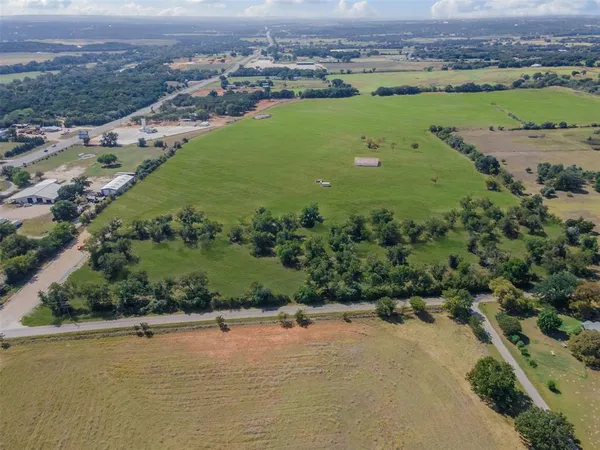 an aerial view of a houses with a yard