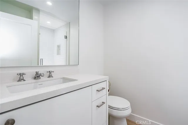 a bathroom with a sink toilet and a mirror