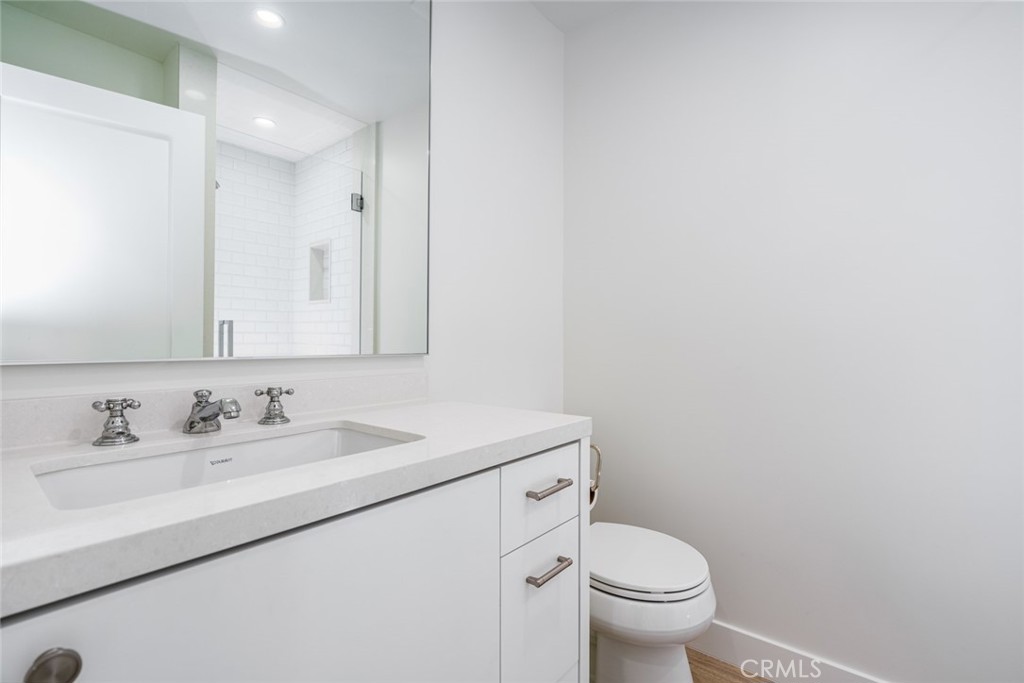 476 Morning Canyon Road Corona del Mar, CA 92625 - Photo 12 of 22 a bathroom with a sink toilet and a mirror