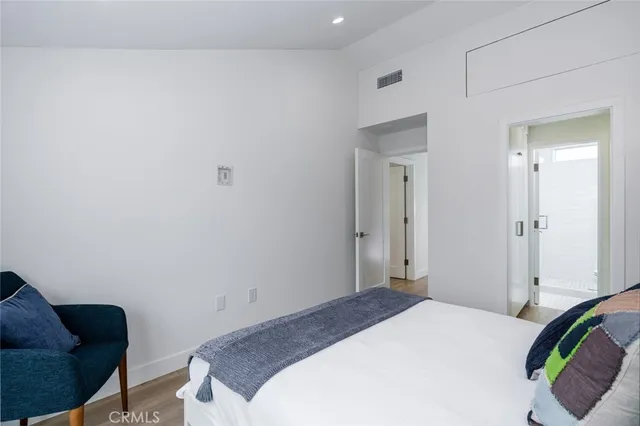 a bedroom with a bed and a couch