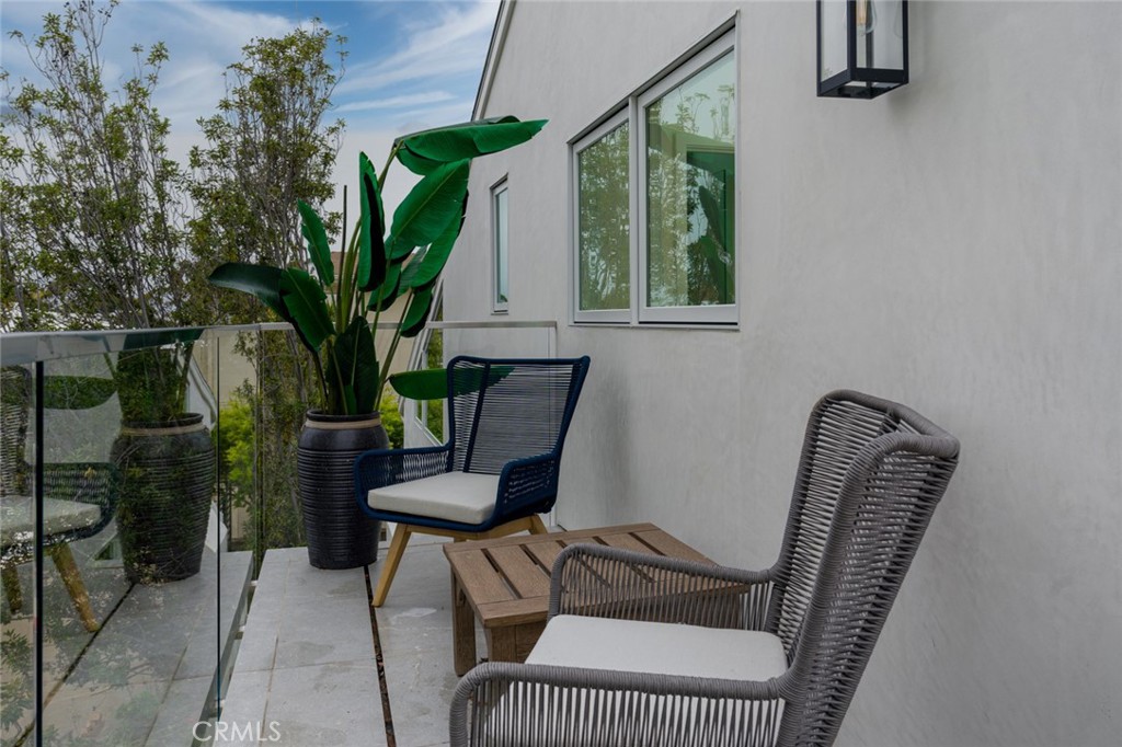 476 Morning Canyon Road Corona del Mar, CA 92625 - Photo 19 of 22 a view of a balcony with chair and potted plants