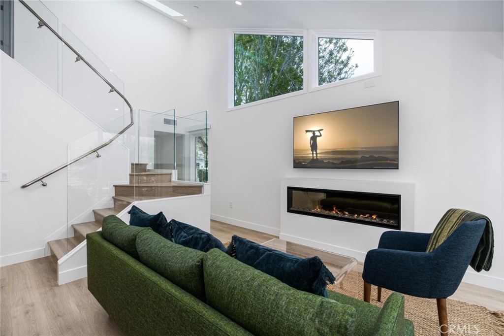 476 Morning Canyon Road Corona del Mar, CA 92625 - Photo 2 of 22 a living room with furniture a flat screen tv and a fireplace