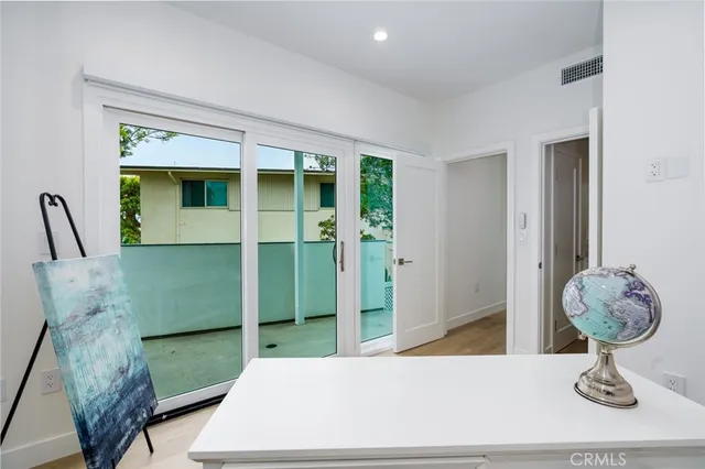 a living room with furniture flowerpot and wooden floor