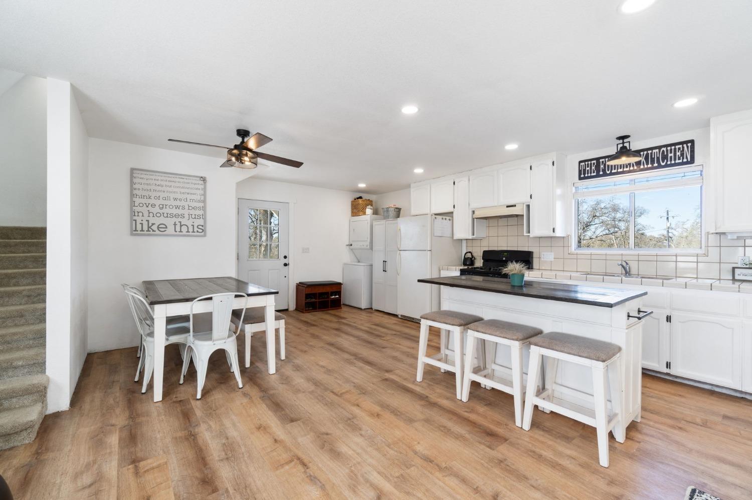 29696 Auberry Road Prather, CA 93651 - Photo 11 of 34 a kitchen with stainless steel appliances granite countertop a dining table chairs stove refrigerator and cabinets
