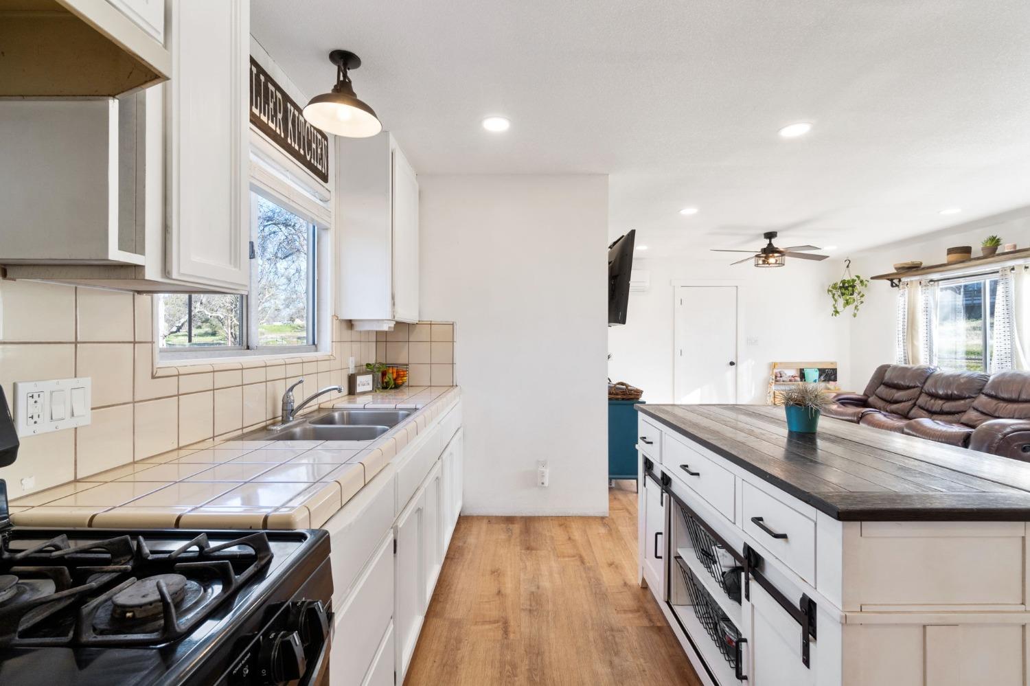 29696 Auberry Road Prather, CA 93651 - Photo 14 of 34 a kitchen with a sink stove and cabinets