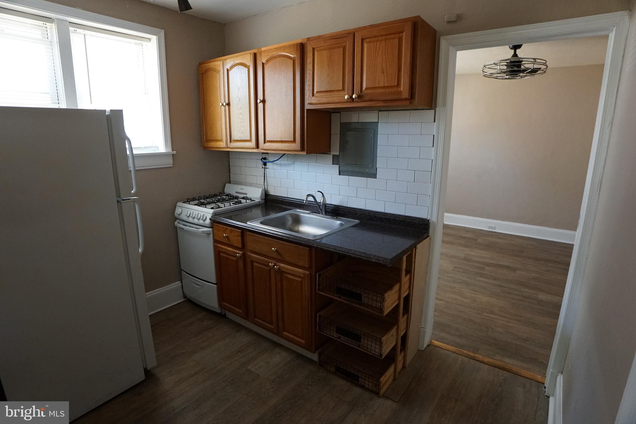 2 Aigburth Road, Unit 1 Towson, MD 21286 - Photo 5 of 10 a kitchen with stainless steel appliances granite countertop a refrigerator and a sink