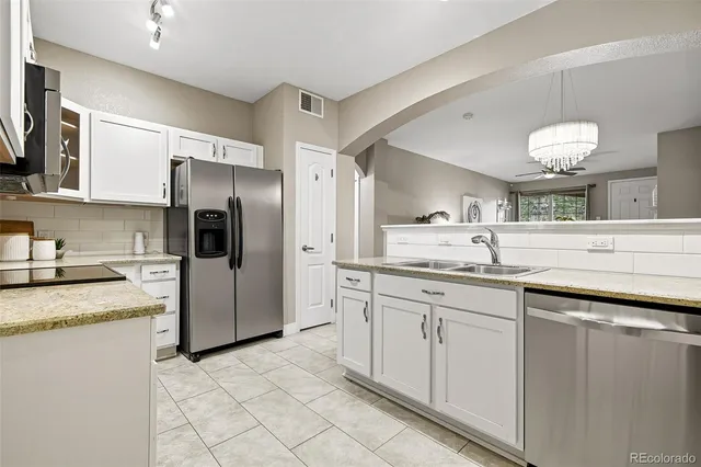 a kitchen with a sink stove and refrigerator
