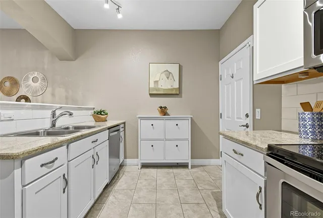a kitchen with a sink stove and cabinets