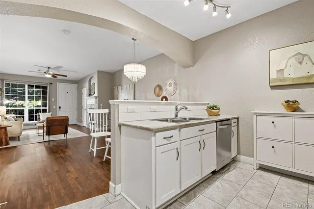 a spacious bathroom with a granite countertop sink a mirror and vanity