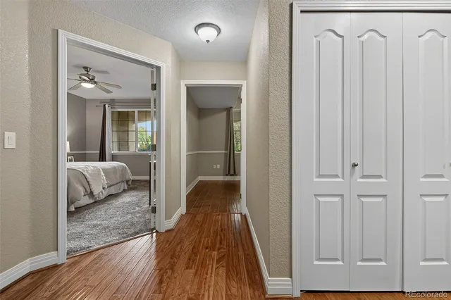 a bedroom with a bed and a view of living room