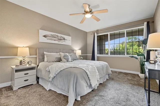 a bedroom with a bed and a tv on the dresser