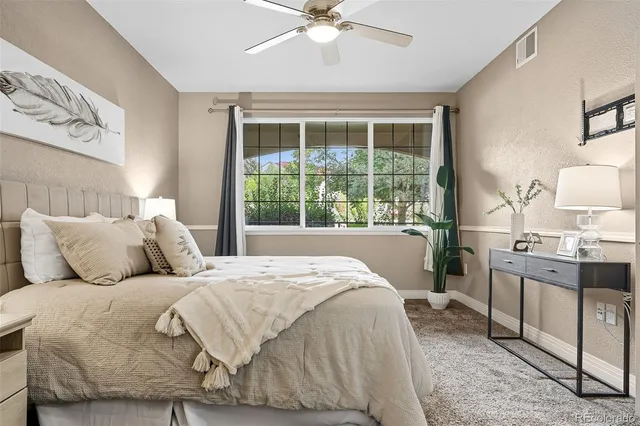 a large bed sitting in a bedroom next to a window