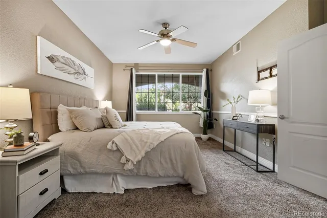 a spacious bedroom with a bed and a chandelier
