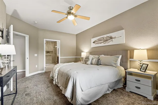 a bedroom with a bed and a lamp on dresser