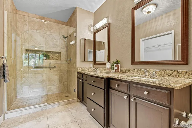 a bathroom with a granite countertop sink mirror and