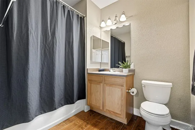 a bathroom with a toilet a sink and a mirror