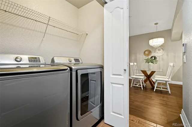 a utility room with dryer washer and stair