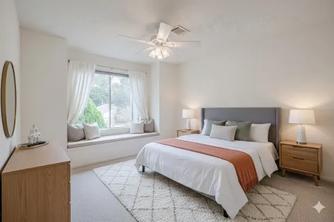 a spacious bedroom with a bed and a chandelier