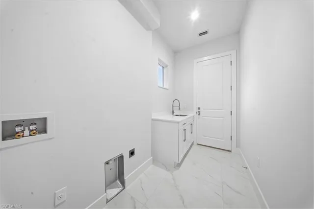 a room with a sink and cabinets