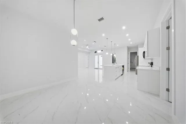 a view of a kitchen with white cabinets