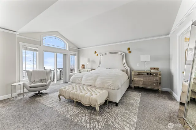 a bedroom with a bed couch and a window