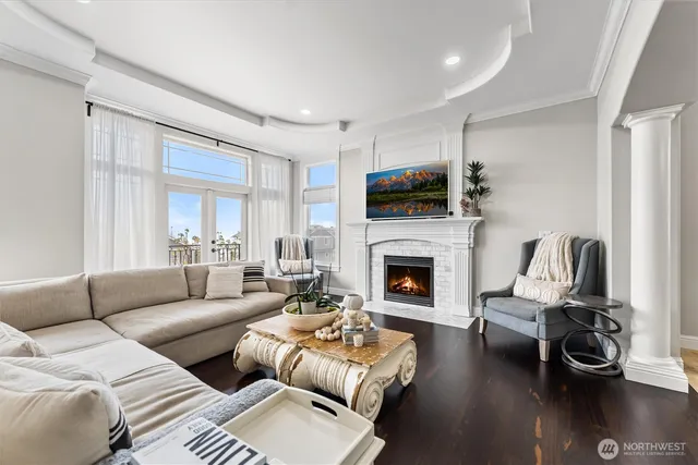 a living room with furniture a fireplace and a flat screen tv