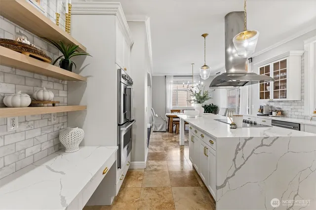 a kitchen with stainless steel appliances granite countertop a sink stove and cabinets