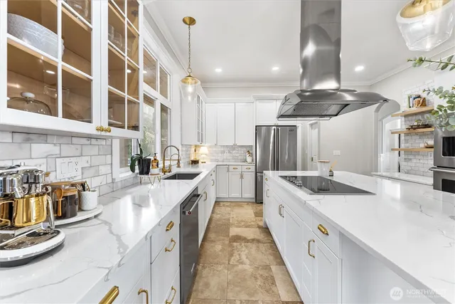 a large kitchen with stainless steel appliances kitchen island granite countertop a sink and cabinets