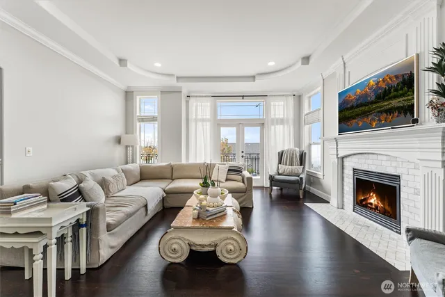 a living room with furniture fireplace and flat screen tv