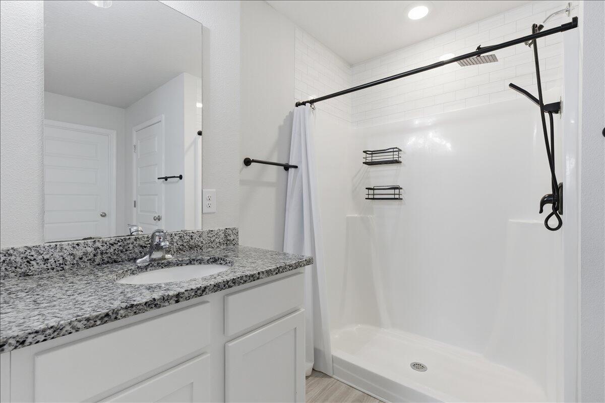 943 Sandbar Loop Crestview, FL 32539 - Photo 34 of 59 a bathroom with a granite countertop shower sink and mirror