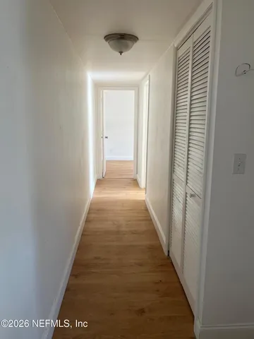 a view of a kitchen with wooden cabinets