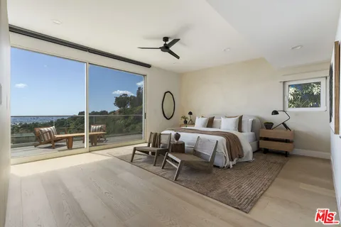 a bed room with a bed and with chair