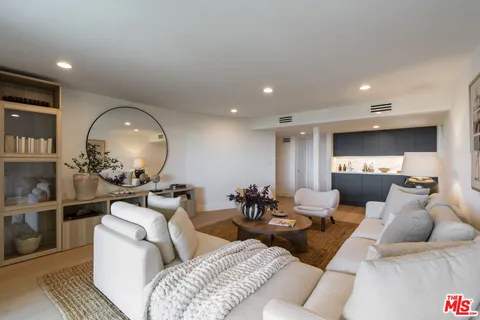 a living room with furniture and a mirror