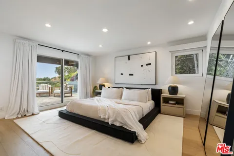 a bedroom with a large bed and a large window