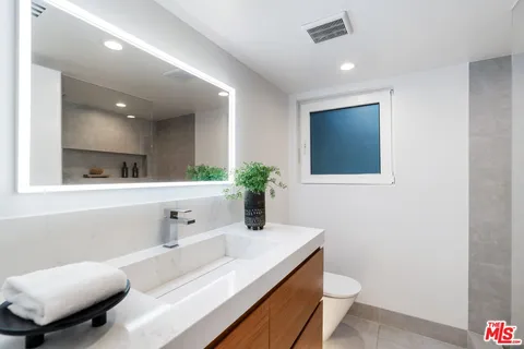 a workspace with furniture and a mirror