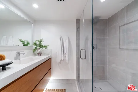 a bathroom with a sink toilet and mirror