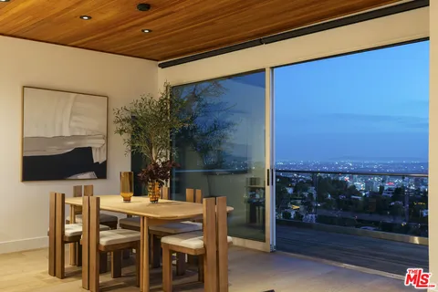 a dining room with furniture and wooden floor