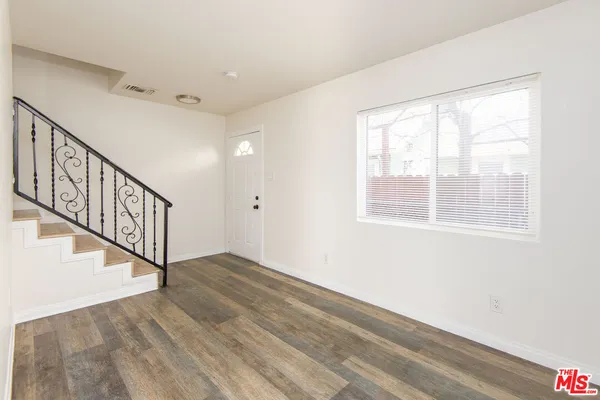 a view of an entryway with wooden floor