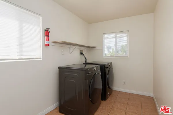 a view of storage and utility room with windows
