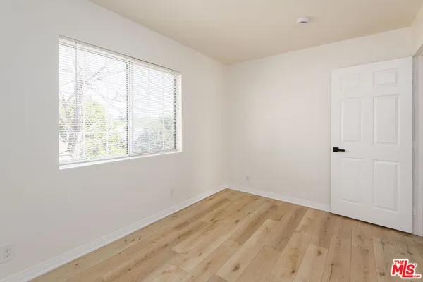 a view of a room with wooden floor and windows in it